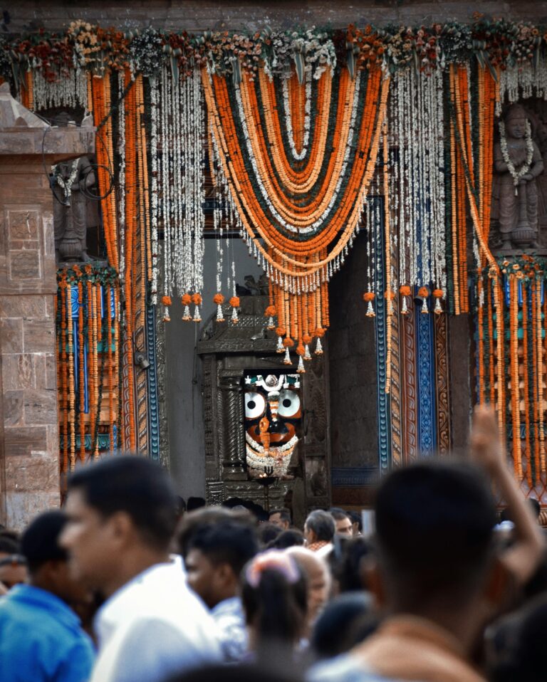 People gather at the decorated entrance of the Jagannath Temple in Puri, India, during a festive celebration.